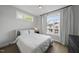 Bright bedroom with hardwood floors, a ceiling fan, and large windows at 221 Woodsborough Pl, Raleigh, NC 27601