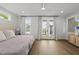 Bright bedroom featuring modern decor, hardwood floors, and access to a private balcony at 221 Woodsborough Pl, Raleigh, NC 27601