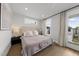 Bedroom featuring modern decor, hardwood floors, and large windows at 221 Woodsborough Pl, Raleigh, NC 27601