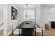 Contemporary dining room with modern art, statement lighting, and seating for six at 221 Woodsborough Pl, Raleigh, NC 27601