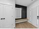 A hallway featuring storage, a bench and a window at 221 Woodsborough Pl, Raleigh, NC 27601