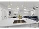 Modern kitchen with a view of the living and dining areas, featuring a large island at 221 Woodsborough Pl, Raleigh, NC 27601