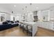 Open concept kitchen featuring a large island with seating and stylish pendant lighting at 221 Woodsborough Pl, Raleigh, NC 27601