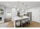 Bright kitchen featuring white cabinets, stainless steel appliances, and a spacious island at 221 Woodsborough Pl, Raleigh, NC 27601