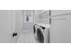 Laundry room with washer, dryer and storage cabinets at 221 Woodsborough Pl, Raleigh, NC 27601