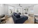 Open-concept living room with a fireplace, television, and large windows for ample natural light at 221 Woodsborough Pl, Raleigh, NC 27601