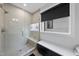 A modern shower with a built-in bench, sleek tile, and a glass door at 221 Woodsborough Pl, Raleigh, NC 27601