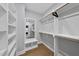 Spacious walk-in closet with custom shelving and a built-in mirror at 221 Woodsborough Pl, Raleigh, NC 27601