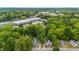 Neighborhood aerial view of homes surrounded by lush greenery and mature trees at 223 Hall Ave, Burlington, NC 27217