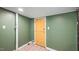 Basement corner with door and white-painted pipes at 223 Hall Ave, Burlington, NC 27217
