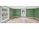 Bedroom features wood-look flooring, neutral walls, and a large window for natural light at 223 Hall Ave, Burlington, NC 27217