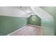 Attic bedroom with hardwood floors, neutral paint, and natural light through a window at 223 Hall Ave, Burlington, NC 27217