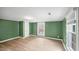 Bedroom featuring wood-look floors, neutral walls, and natural light from windows at 223 Hall Ave, Burlington, NC 27217