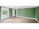 Light-filled bedroom featuring wood-look flooring, neutral walls, and ample natural light through the window at 223 Hall Ave, Burlington, NC 27217