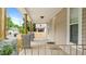 Spacious front porch featuring decorative columns and railing, perfect for relaxing outdoors at 223 Hall Ave, Burlington, NC 27217