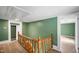 Hallway showing railing and steps leading to other rooms at 223 Hall Ave, Burlington, NC 27217