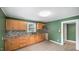Well-lit kitchen with wooden cabinetry, granite countertops, and modern appliances for culinary enthusiasts at 223 Hall Ave, Burlington, NC 27217