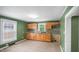 Well-lit kitchen with tile floors, wood cabinets, tile backsplash, and stainless steel sink at 223 Hall Ave, Burlington, NC 27217