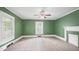 Spacious living room featuring tile floors, a ceiling fan, and an elegant decorative fireplace at 223 Hall Ave, Burlington, NC 27217