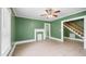Bright living room features tile floors and a decorative fireplace, leading to a staircase at 223 Hall Ave, Burlington, NC 27217