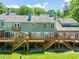 Aerial view of townhomes with private decks and lush green backyard at 2303 Upper Oaks Way, Raleigh, NC 27615