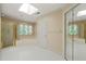 Bright bathroom with skylight, a tub, walk-in shower, and mirrored closet at 2303 Upper Oaks Way, Raleigh, NC 27615