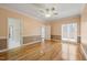 Spacious bedroom featuring hardwood floors, a ceiling fan, and natural light from a window at 2303 Upper Oaks Way, Raleigh, NC 27615