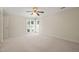 Light filled bedroom featuring neutral carpet, white walls, many windows and a ceiling fan at 2303 Upper Oaks Way, Raleigh, NC 27615