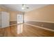 Bedroom features hardwood flooring, wainscoting, and a window for natural light at 2303 Upper Oaks Way, Raleigh, NC 27615