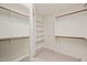 Spacious walk-in closet with ample shelving and wooden clothes rods offering plenty of storage at 2303 Upper Oaks Way, Raleigh, NC 27615