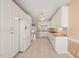 Bright kitchen features white cabinetry, tile flooring, and granite countertops, offering a clean and functional space at 2303 Upper Oaks Way, Raleigh, NC 27615