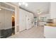 Open kitchen showcases white cabinets, granite counters, stainless appliances, and access to a bathroom at 2303 Upper Oaks Way, Raleigh, NC 27615