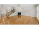 Bright living room with hardwood floors, fireplace, and staircase for an open-concept design at 2303 Upper Oaks Way, Raleigh, NC 27615
