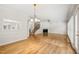 Open-concept living room featuring hardwood floors, fireplace, crown molding, and staircase at 2303 Upper Oaks Way, Raleigh, NC 27615