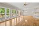 Open-concept living area with hardwood floors, chandelier, access to a deck, and adjoining dining space at 2303 Upper Oaks Way, Raleigh, NC 27615