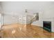 Expansive living area with hardwood floors, fireplace, and a staircase, complemented by natural light at 2303 Upper Oaks Way, Raleigh, NC 27615