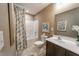 Bathroom featuring a single sink vanity with a tiled floor, and a shower/tub at 238 Oak Meadow Ln, Angier, NC 27501