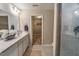 Bright bathroom featuring a double sink vanity, decorative accents, tile flooring and a walk-in closet at 238 Oak Meadow Ln, Angier, NC 27501