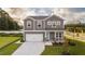 Charming two-story home featuring a light blue front door and manicured lawn at 238 Oak Meadow Ln, Angier, NC 27501