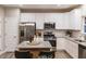 Bright kitchen featuring white cabinets, stainless appliances, and granite countertops at 238 Oak Meadow Ln, Angier, NC 27501