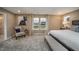 Spacious main bedroom features a large bed, bench, and ample natural light from two windows at 238 Oak Meadow Ln, Angier, NC 27501