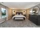 Spacious main bedroom features a large bed, bench, and ample natural light from two windows at 238 Oak Meadow Ln, Angier, NC 27501