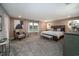 Spacious main bedroom features a large bed, bench, and ample natural light from two windows at 238 Oak Meadow Ln, Angier, NC 27501