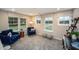 Bright sitting room with comfortable blue chairs, soft carpet, and three large windows at 238 Oak Meadow Ln, Angier, NC 27501