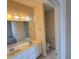 Bright bathroom with double vanity, white cabinets, and a large mirror over the sinks at 2521 Friedland Pl # 301, Raleigh, NC 27617