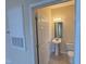 The bathroom features a pedestal sink, mirror, and modern fixtures at 2521 Friedland Pl # 301, Raleigh, NC 27617