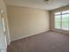 Bright bedroom with neutral walls, carpet flooring, and a large window at 2521 Friedland Pl # 301, Raleigh, NC 27617