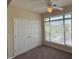 Bedroom featuring a ceiling fan, carpet floors, a window, and a closet at 2521 Friedland Pl # 301, Raleigh, NC 27617
