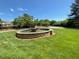 Water fountain with manicured green grass under a blue sky at 2521 Friedland Pl # 301, Raleigh, NC 27617