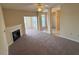 Spacious living room featuring neutral tones, a ceiling fan and a cozy fireplace at 2521 Friedland Pl # 301, Raleigh, NC 27617